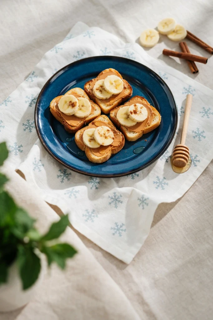 Toast quarters with peanut butter, banana slices, and honey drizzle