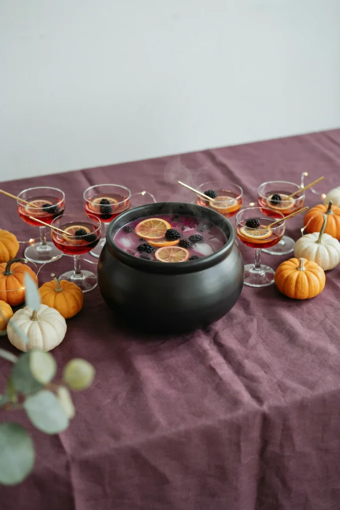 Black cauldron-style bowl of witches' brew punch on a table for a kids Halloween party