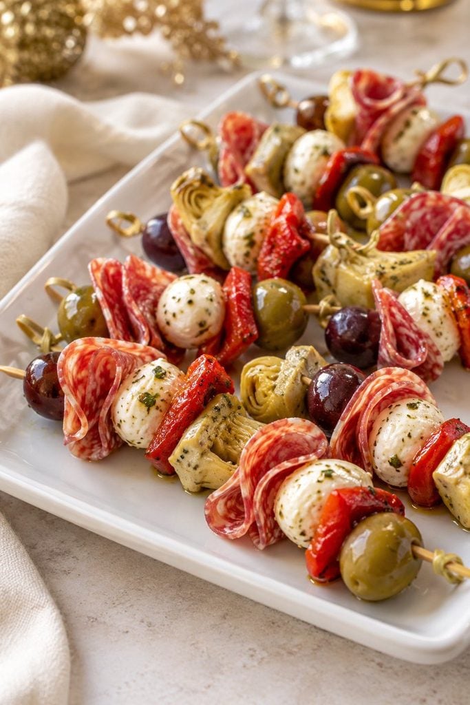 Antipasto skewers with salami, marinated mozzarella, olives, and roasted red pepper